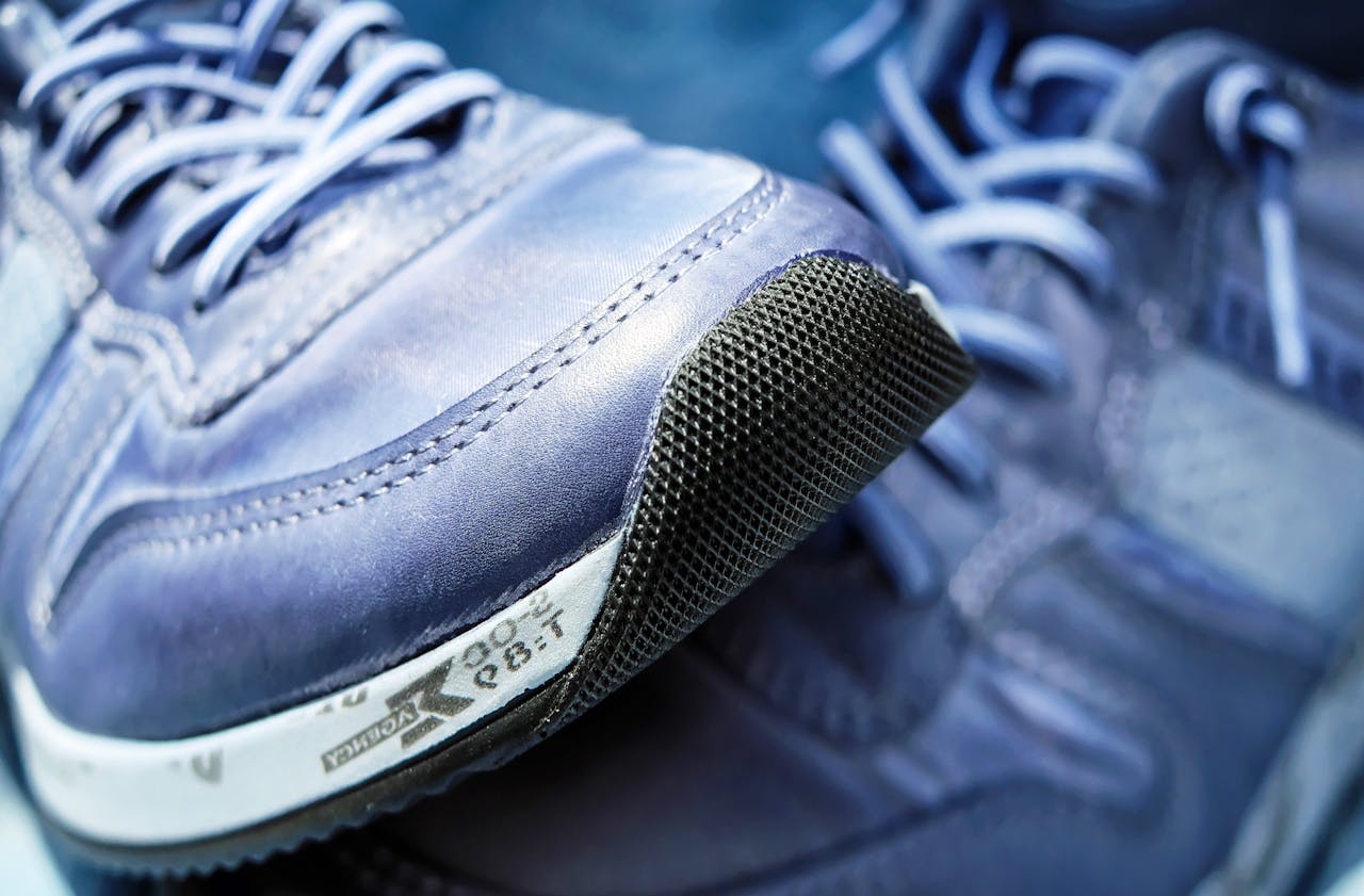 Detailed view of blue athletic sneakers showcasing mesh textures and laces.